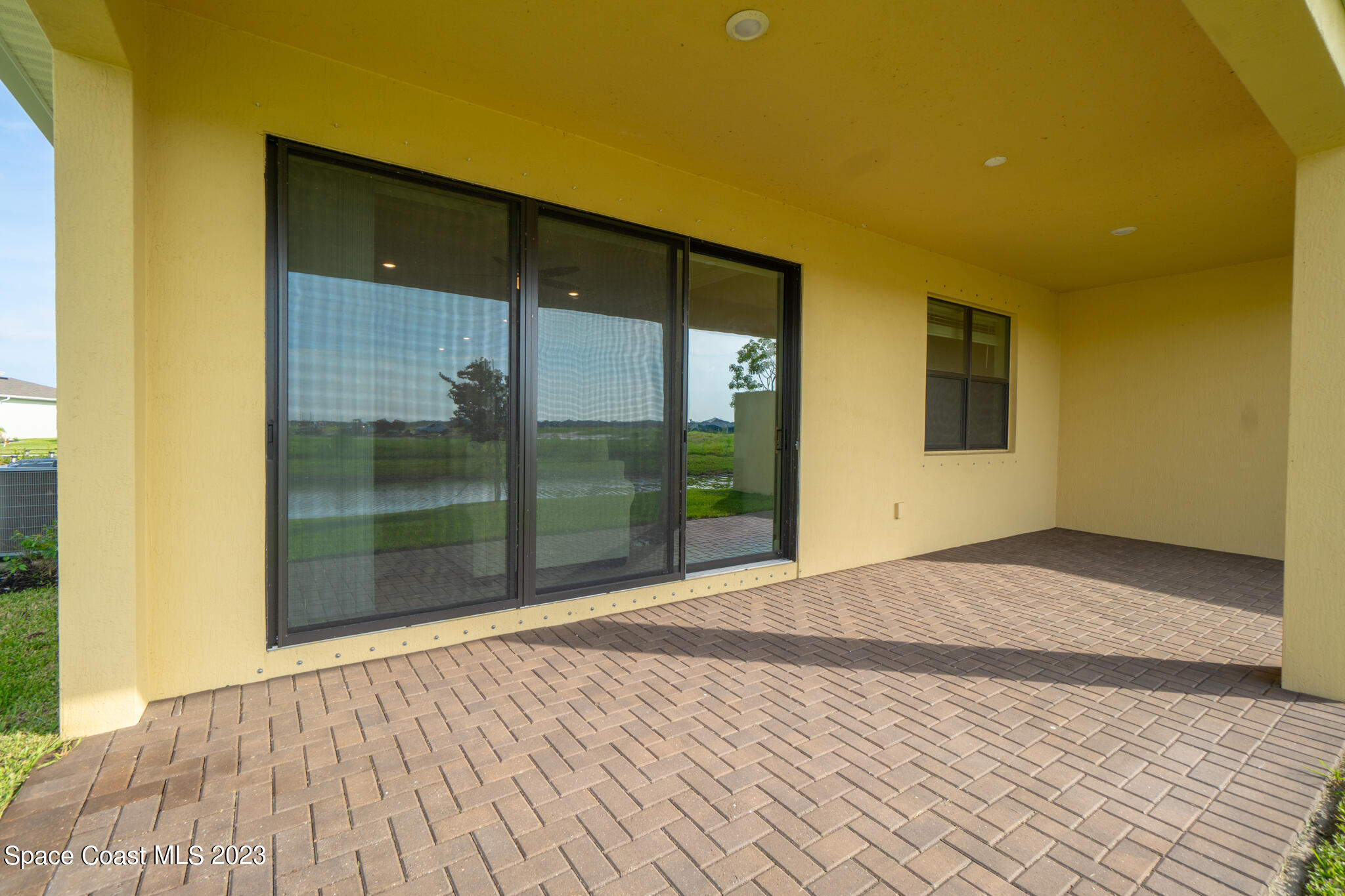 9753 Alister Drive Melbourne, FL 32940 - Photo 19 of 42 a view of empty room with wooden floor and fan