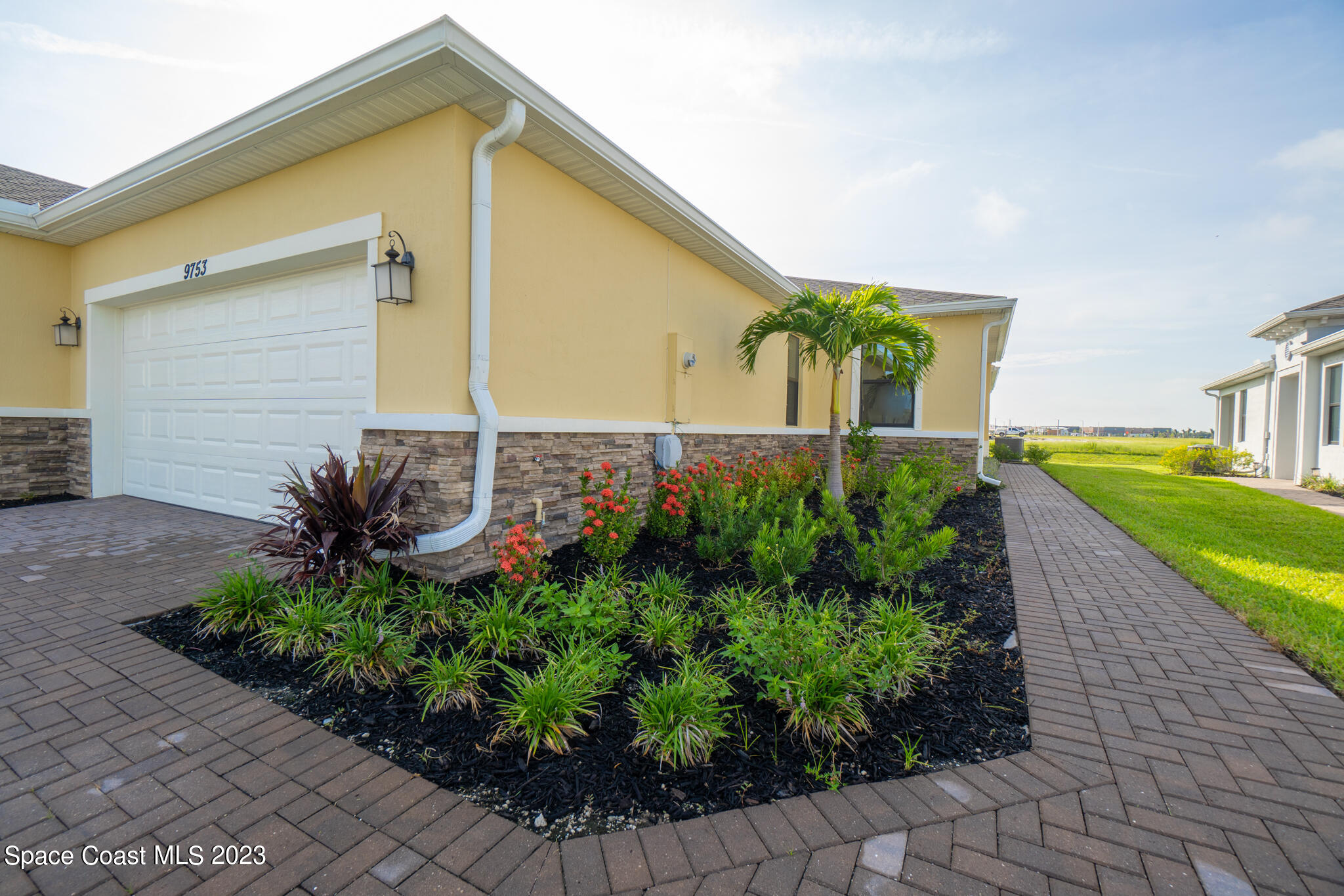 9753 Alister Drive Melbourne, FL 32940 - Photo 2 of 42 a front view of a house with garden