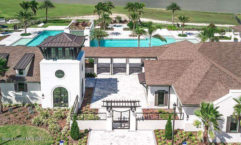 9753 Alister Drive Melbourne, FL 32940 - Photo 40 of 42 a front view of a house with garden