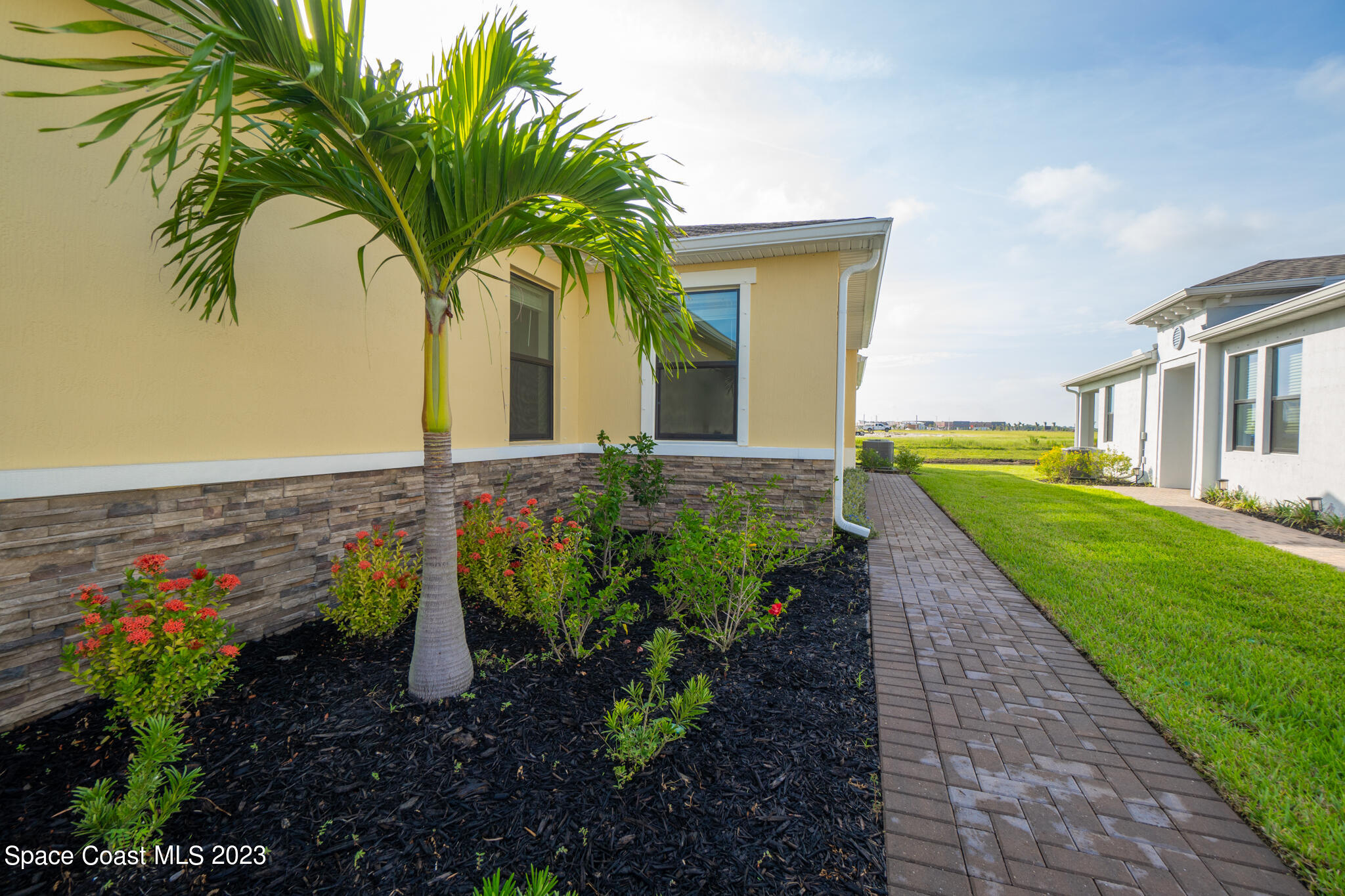 9753 Alister Drive Melbourne, FL 32940 - Photo 5 of 42 a front view of a house with garden