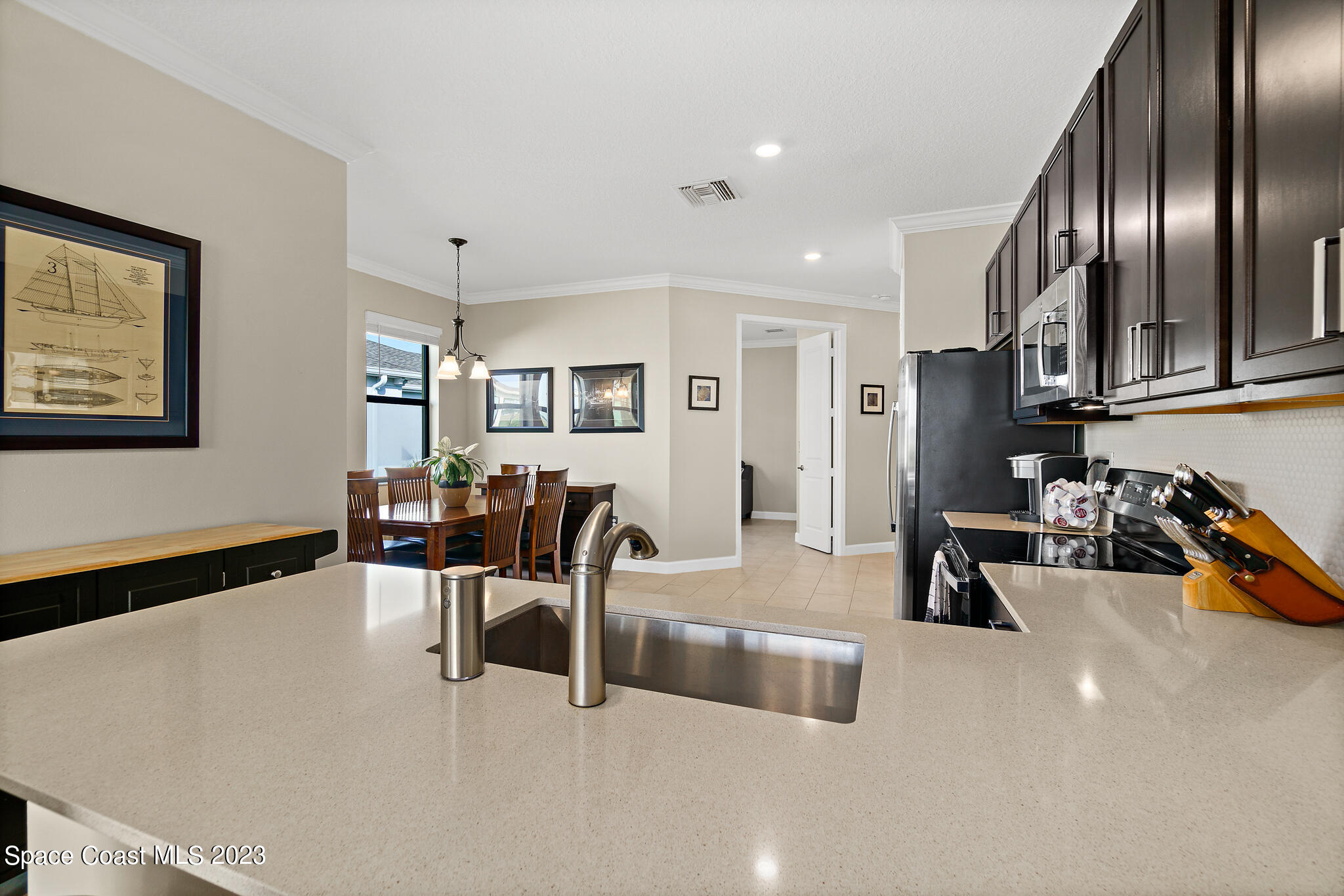 9753 Alister Drive Melbourne, FL 32940 - Photo 9 of 42 a living room with furniture and wooden floor