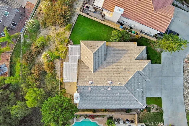 a front view of a house with a garden and trees