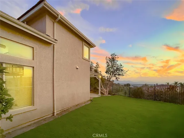 an aerial view of residential houses with outdoor space and city view