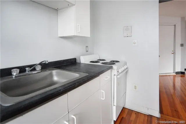 a kitchen that has a sink and a stove