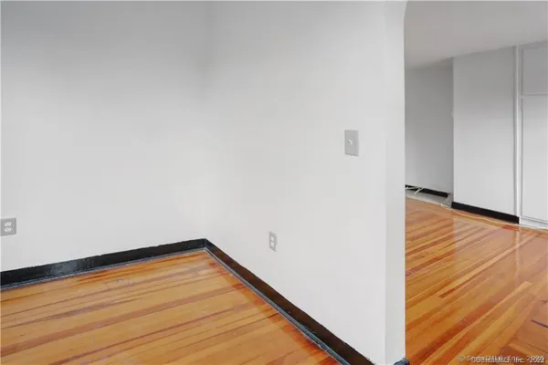 a view of a room with wooden floor