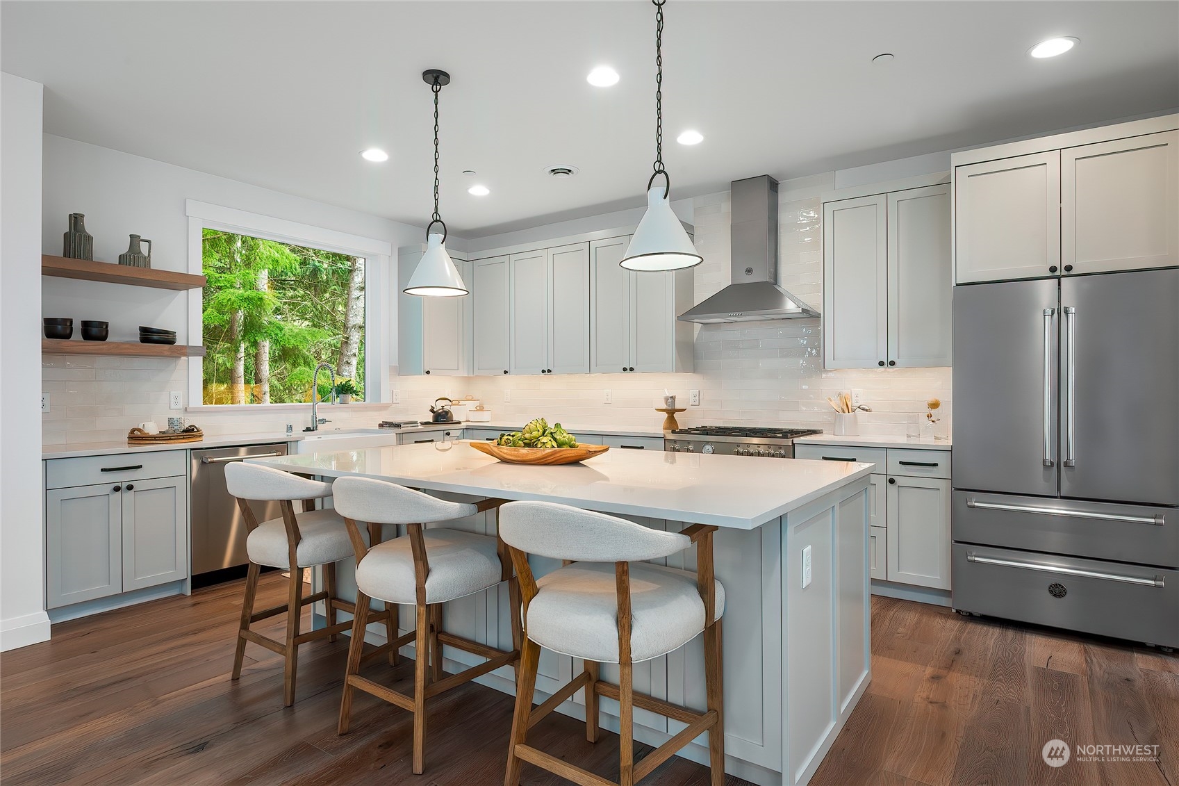 309 174th Street Southeast Bothell, WA 98012 - Photo 12 of 35 a kitchen with kitchen island a stove a table and chairs in it