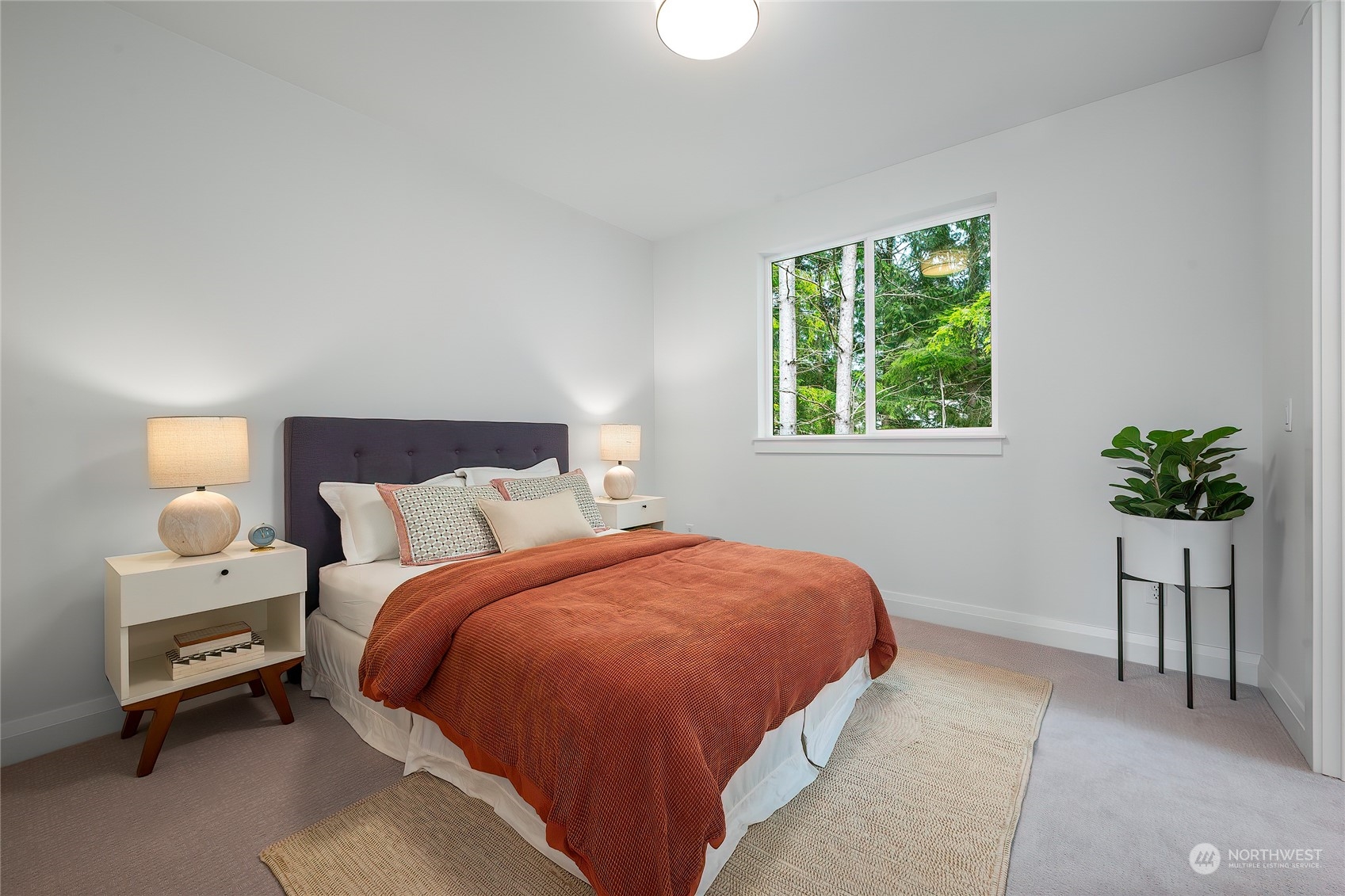 309 174th Street Southeast Bothell, WA 98012 - Photo 30 of 35 a bedroom with a bed and a potted plant