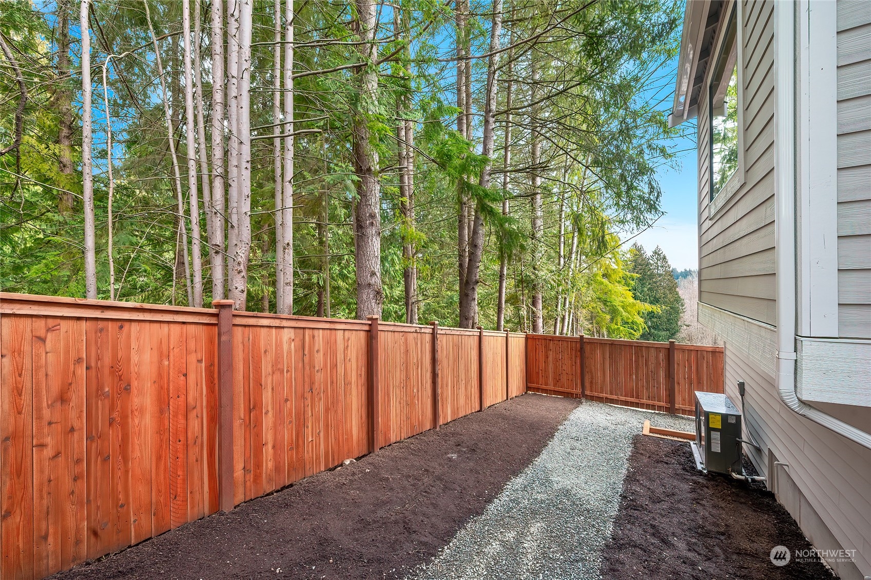 309 174th Street Southeast Bothell, WA 98012 - Photo 34 of 35 a view of a backyard with a trees and wooden fence