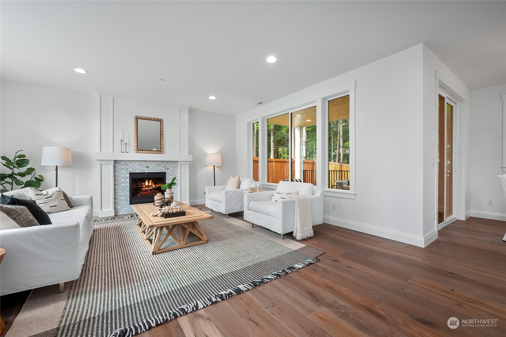 309 174th Street Southeast Bothell, WA 98012 - Photo 6 of 35 a living room with furniture a large window and a fireplace