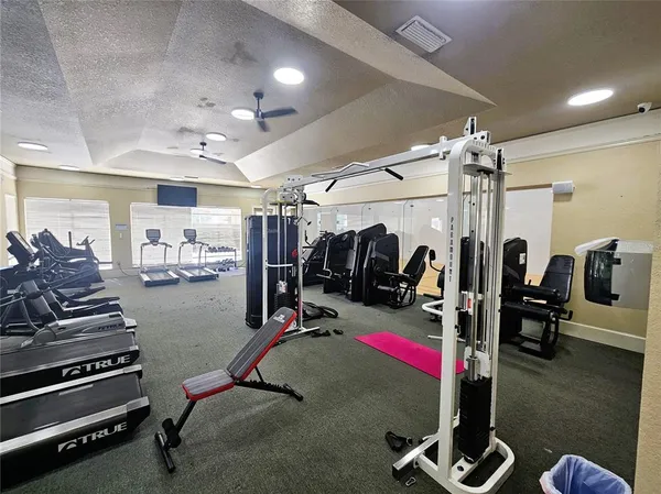 a room with gym equipment and a large window