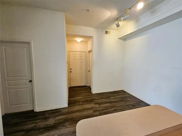 a room with wooden floor and white doors