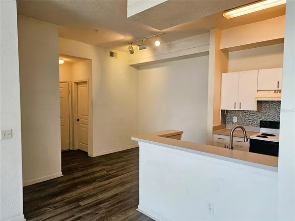 a kitchen with a refrigerator and a stove top oven