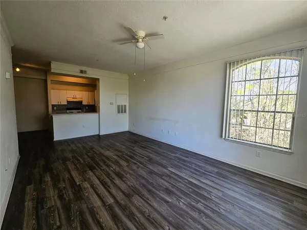 a view of a room with wooden floor and white walls