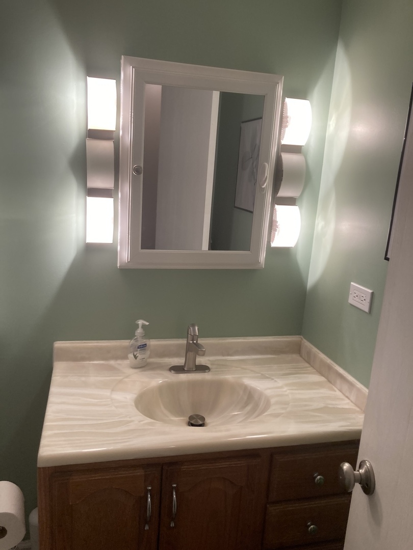 2461 Spring Street, Unit 3504 Woodridge, IL 60517 - Photo 15 of 20 a bathroom with a sink and a mirror