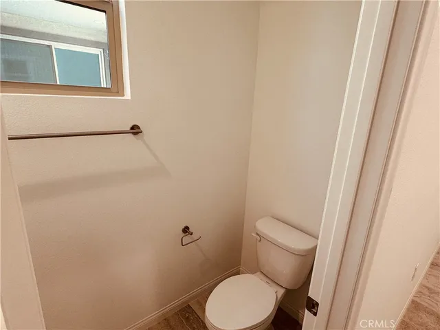 a white toilet sitting next to a shower