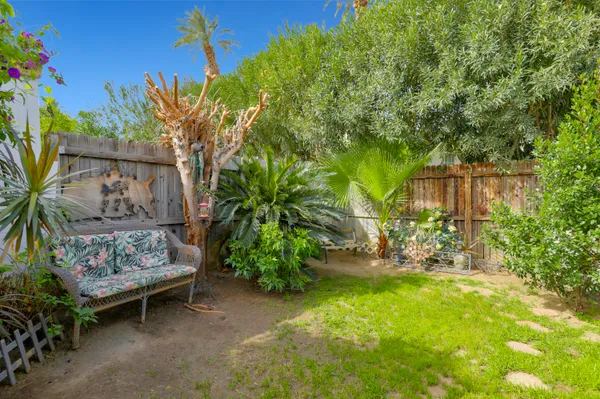 a garden with trees in front of it