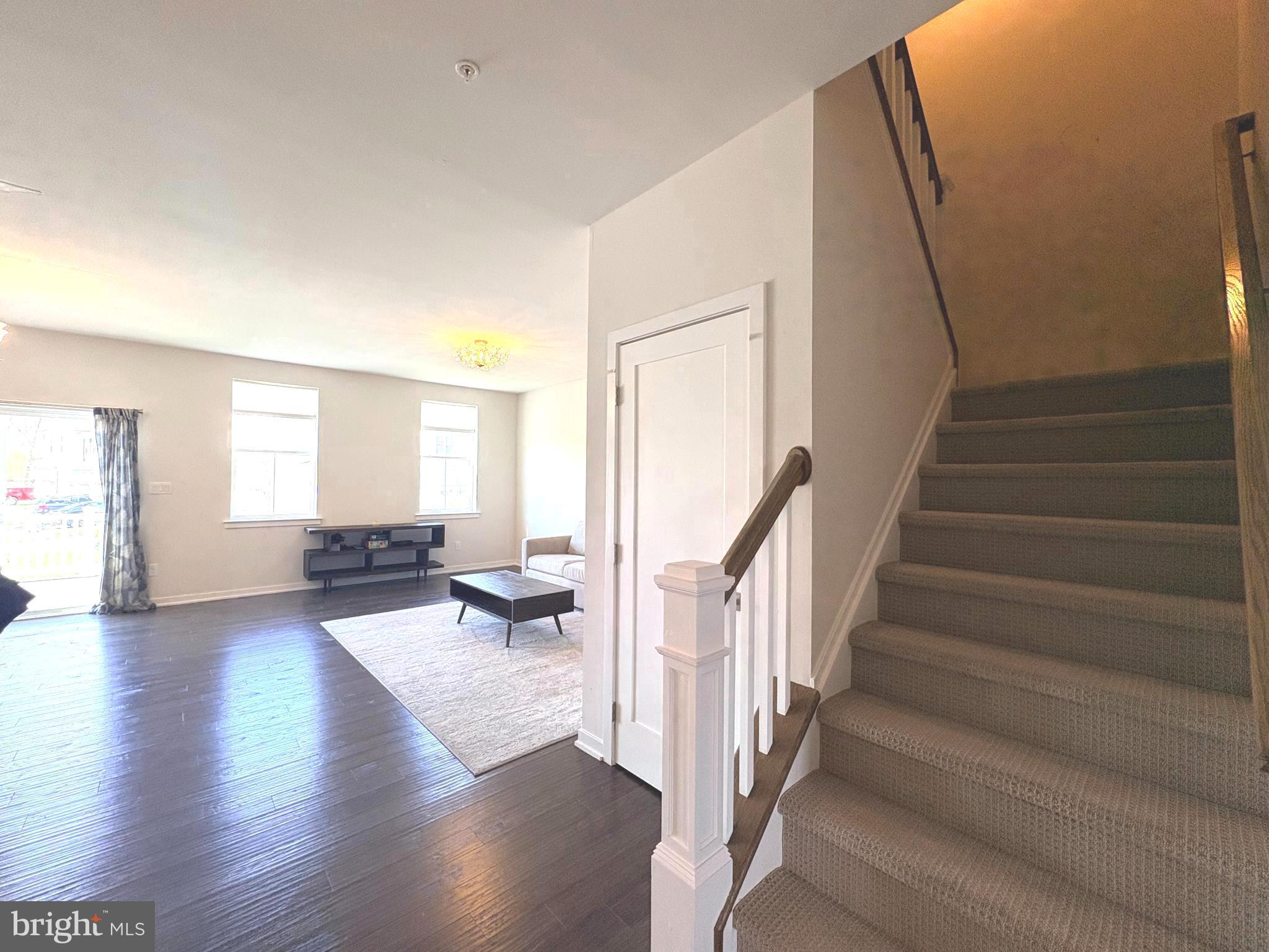 113 Wynstone Court Colmar, PA 18915 - Photo 8 of 20 a view of a livingroom with wooden floor and stairs