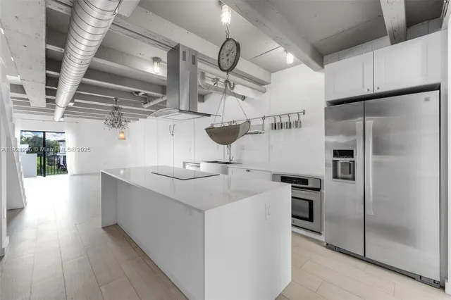 a kitchen with stainless steel appliances a refrigerator and a sink