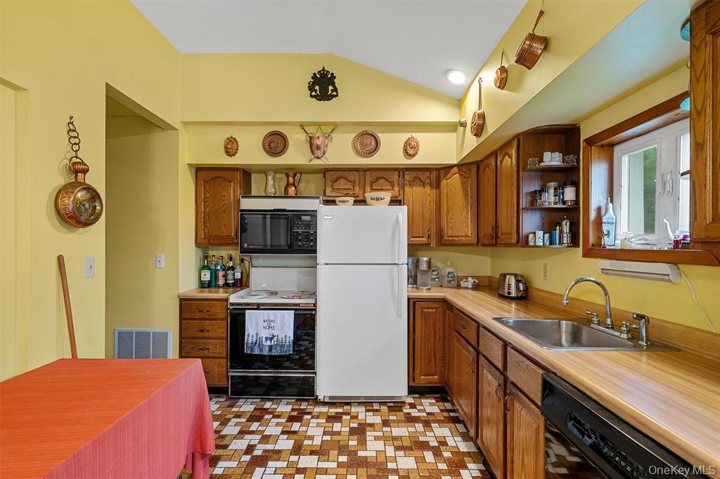 1013 Cooley Road Parksville, NY 12768 - Photo 12 of 44 a kitchen with stainless steel appliances granite countertop a sink and a refrigerator