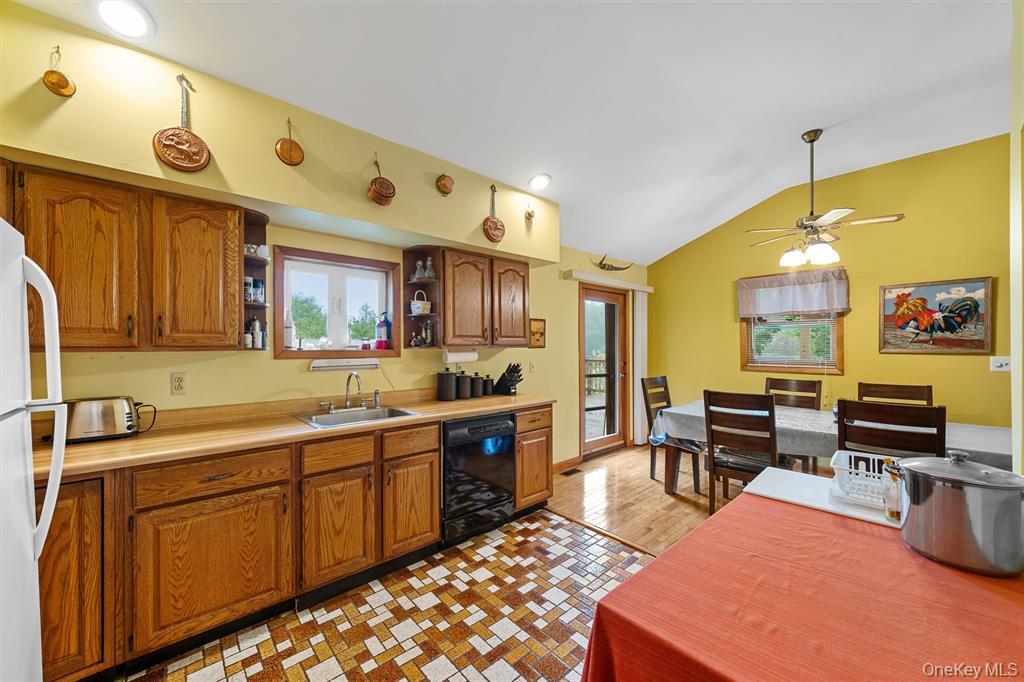 1013 Cooley Road Parksville, NY 12768 - Photo 14 of 44 a large kitchen with a table and chairs in it