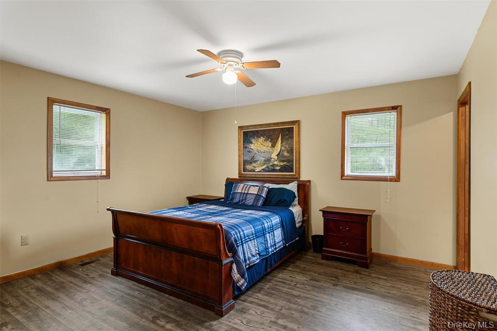 1013 Cooley Road Parksville, NY 12768 - Photo 17 of 44 a bedroom with a bed and a painting on the wall