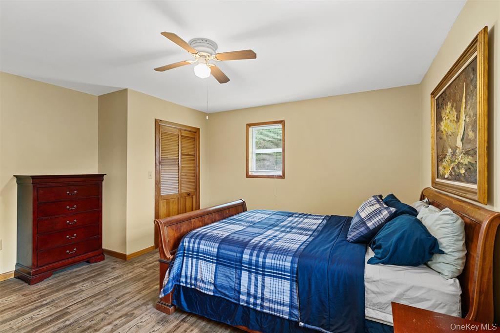 1013 Cooley Road Parksville, NY 12768 - Photo 18 of 44 a bedroom with a bed and wooden floor
