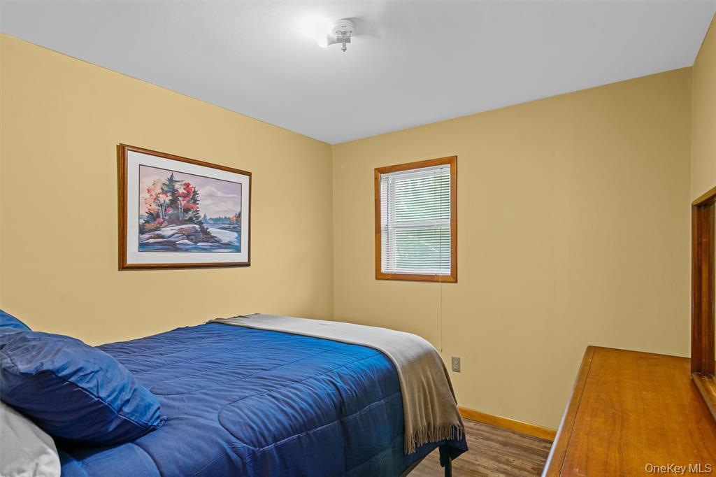 1013 Cooley Road Parksville, NY 12768 - Photo 23 of 44 a bedroom with a bed and a painting on the wall