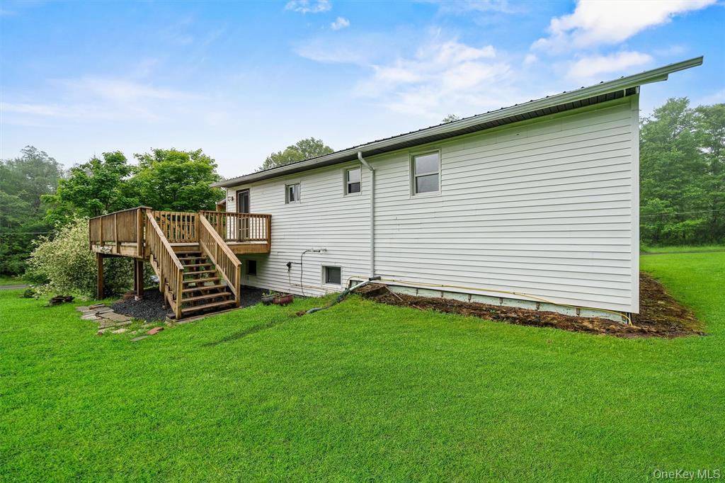 1013 Cooley Road Parksville, NY 12768 - Photo 33 of 44 a backyard of a house with table and chairs
