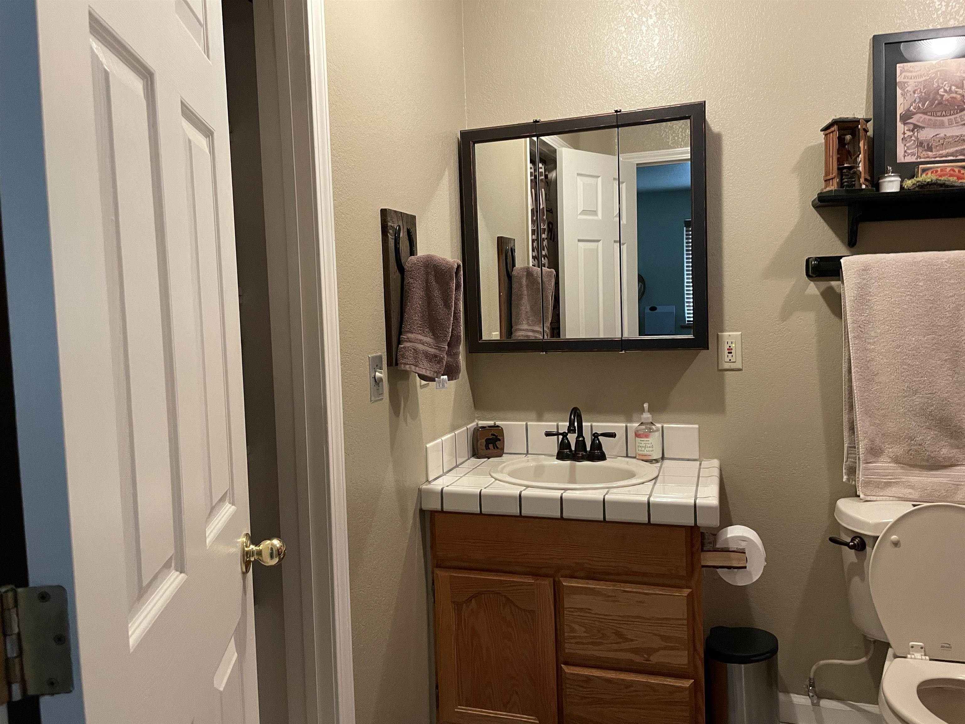 1154 Rocky Cliff Road Portola, CA 96122 - Photo 11 of 15 a bathroom with a sink a toilet and mirror