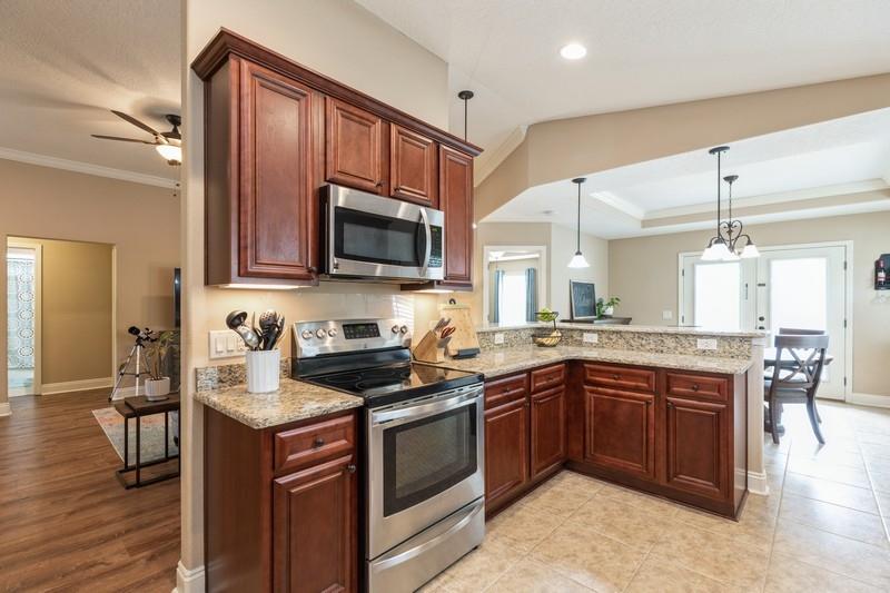 2693 Hartman Court Navarre, FL 32566 - Photo 12 of 34 a kitchen with a sink stove and microwave