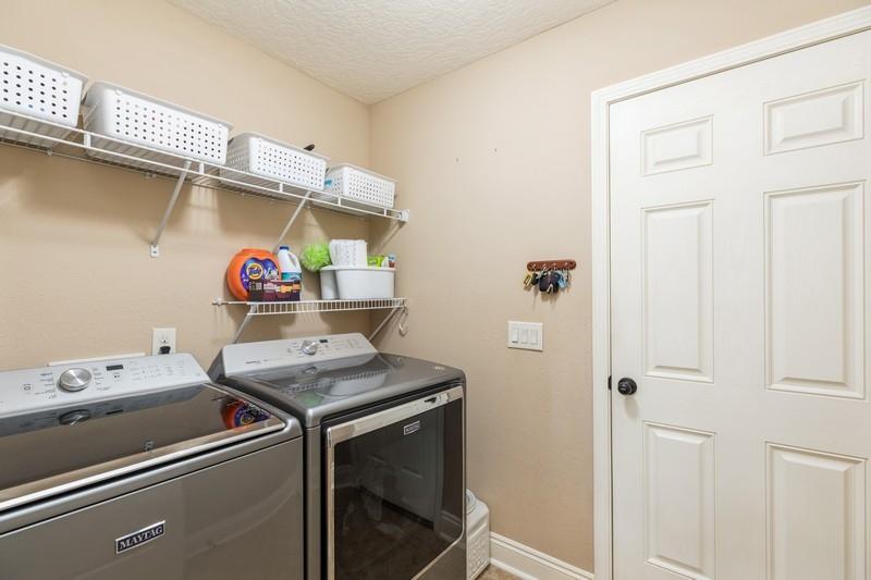 2693 Hartman Court Navarre, FL 32566 - Photo 16 of 34 a utility room with dryer and washer