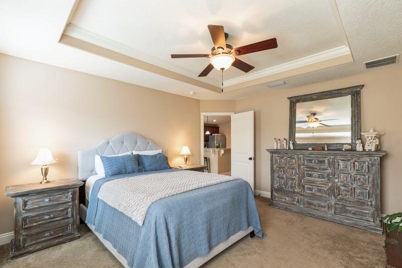 2693 Hartman Court Navarre, FL 32566 - Photo 18 of 34 a bedroom with a bed and a chandelier