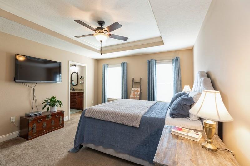 2693 Hartman Court Navarre, FL 32566 - Photo 19 of 34 a bedroom with a bed and a flat screen tv