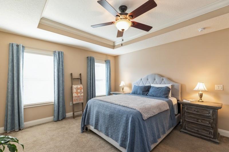 2693 Hartman Court Navarre, FL 32566 - Photo 20 of 34 a bedroom with a bed and a chandelier