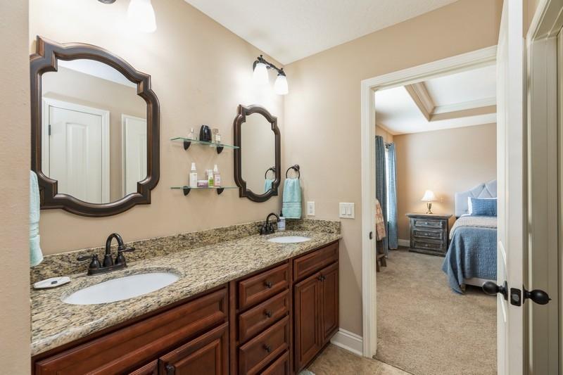 2693 Hartman Court Navarre, FL 32566 - Photo 21 of 34 a en suite bathroom with a granite countertop double vanity sink and a mirror