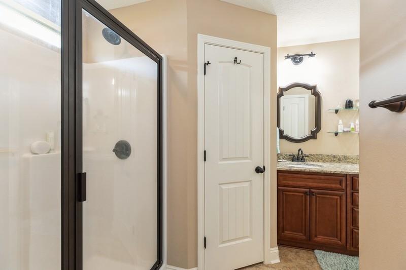 2693 Hartman Court Navarre, FL 32566 - Photo 23 of 34 a bathroom with a granite countertop sink and a mirror