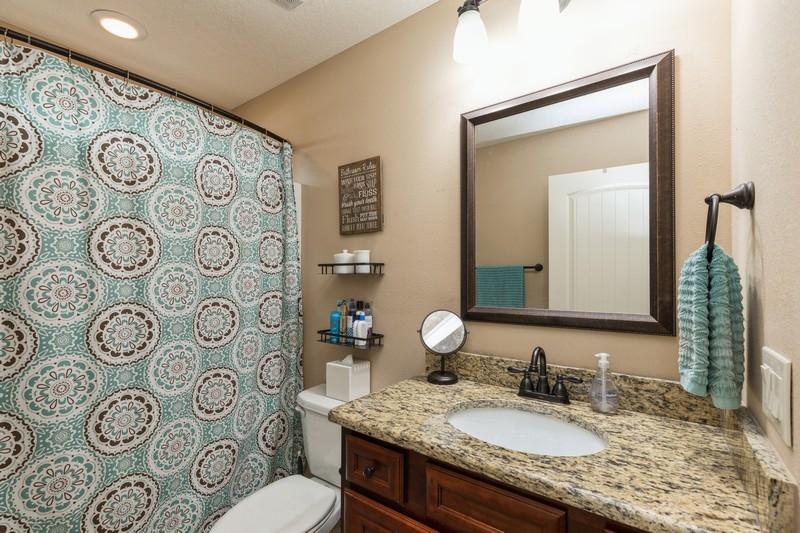 2693 Hartman Court Navarre, FL 32566 - Photo 28 of 34 a bathroom with a granite countertop toilet sink and mirror
