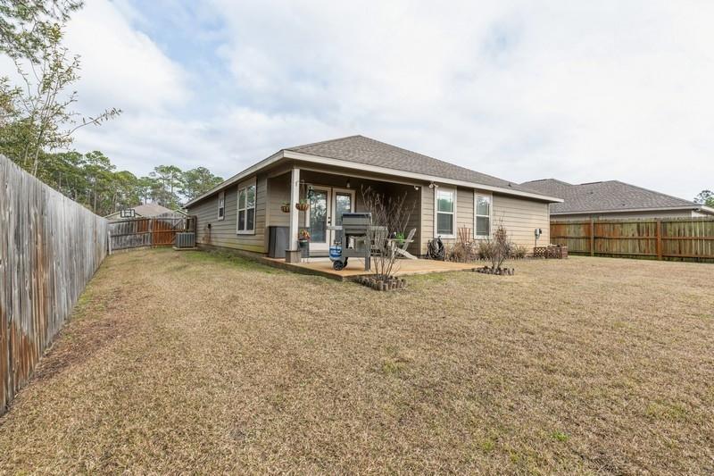 2693 Hartman Court Navarre, FL 32566 - Photo 30 of 34 a view of a house with a yard
