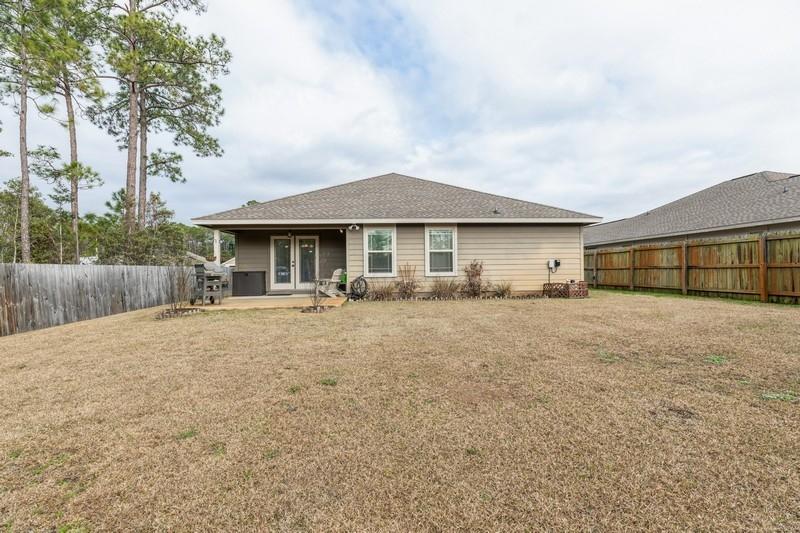 2693 Hartman Court Navarre, FL 32566 - Photo 31 of 34 a front view of a house with a garden