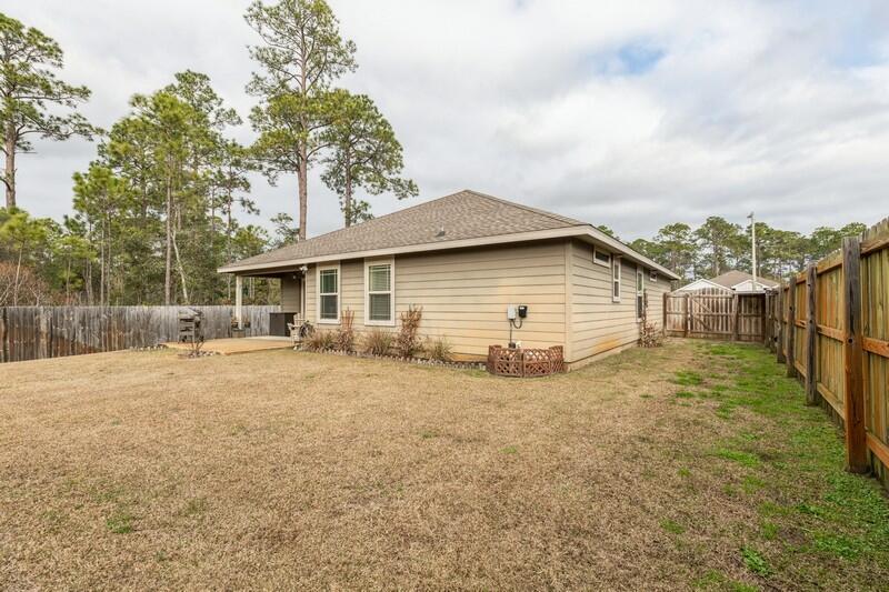2693 Hartman Court Navarre, FL 32566 - Photo 33 of 34 a view of a house with backyard and trees