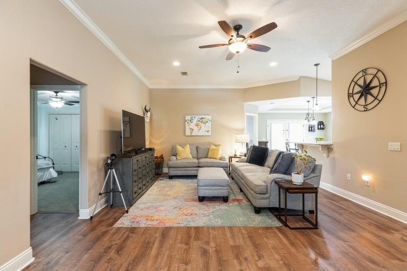 2693 Hartman Court Navarre, FL 32566 - Photo 4 of 34 a living room with furniture a clock on wall and a window