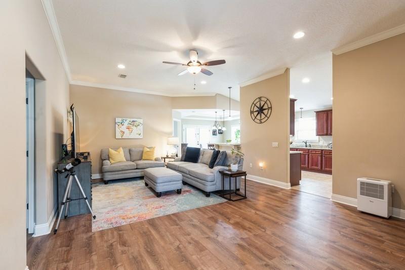 2693 Hartman Court Navarre, FL 32566 - Photo 5 of 34 a living room with furniture and a chandelier