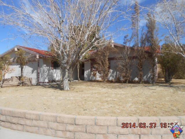 300 Traci Lane Ridgecrest, CA 93555 - Photo 1 of 7 a view of a yard covered with snow in front of house