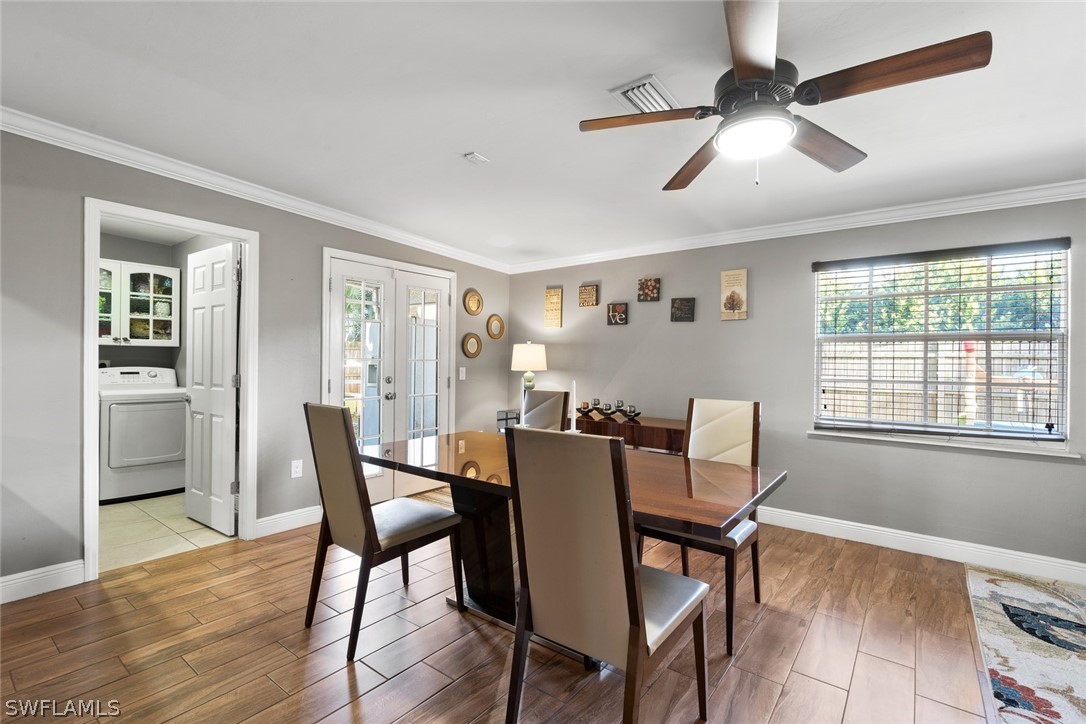 1447 Collins Road Fort Myers, FL 33919 - Photo 14 of 34 a view of a dining room with furniture window and wooden floor
