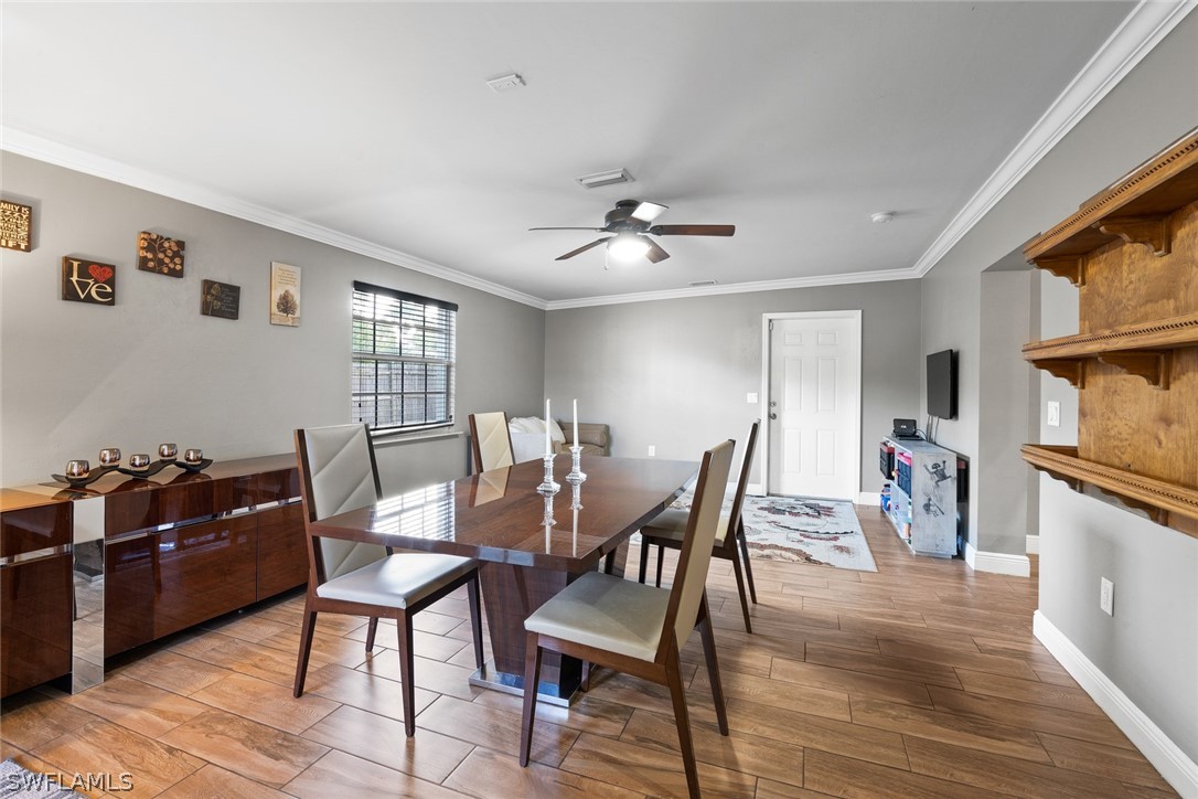 1447 Collins Road Fort Myers, FL 33919 - Photo 16 of 34 a view of a dining room with furniture and chandelier