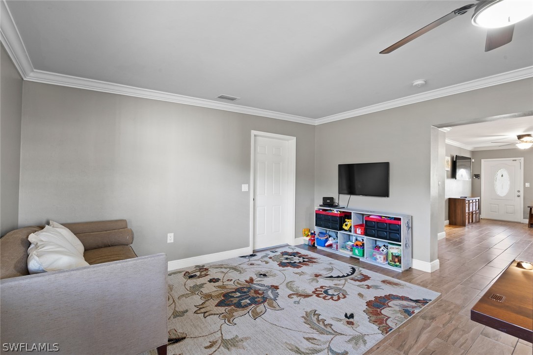 1447 Collins Road Fort Myers, FL 33919 - Photo 18 of 34 a bedroom with a bed and a flat screen tv