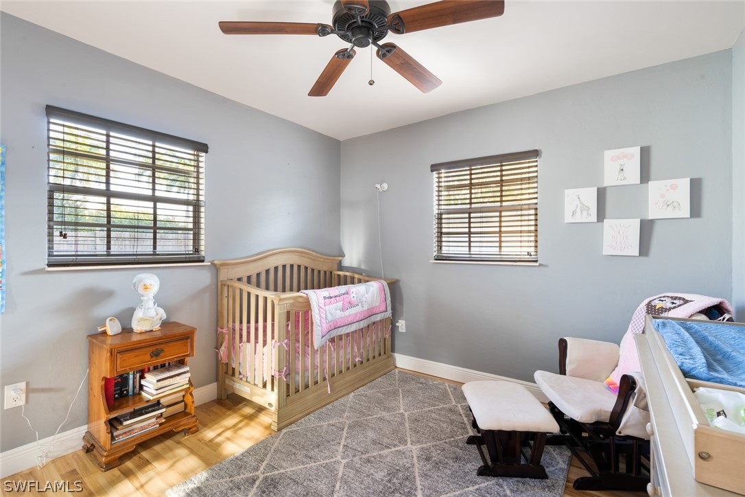 1447 Collins Road Fort Myers, FL 33919 - Photo 19 of 34 a bedroom with a bed and a chandelier