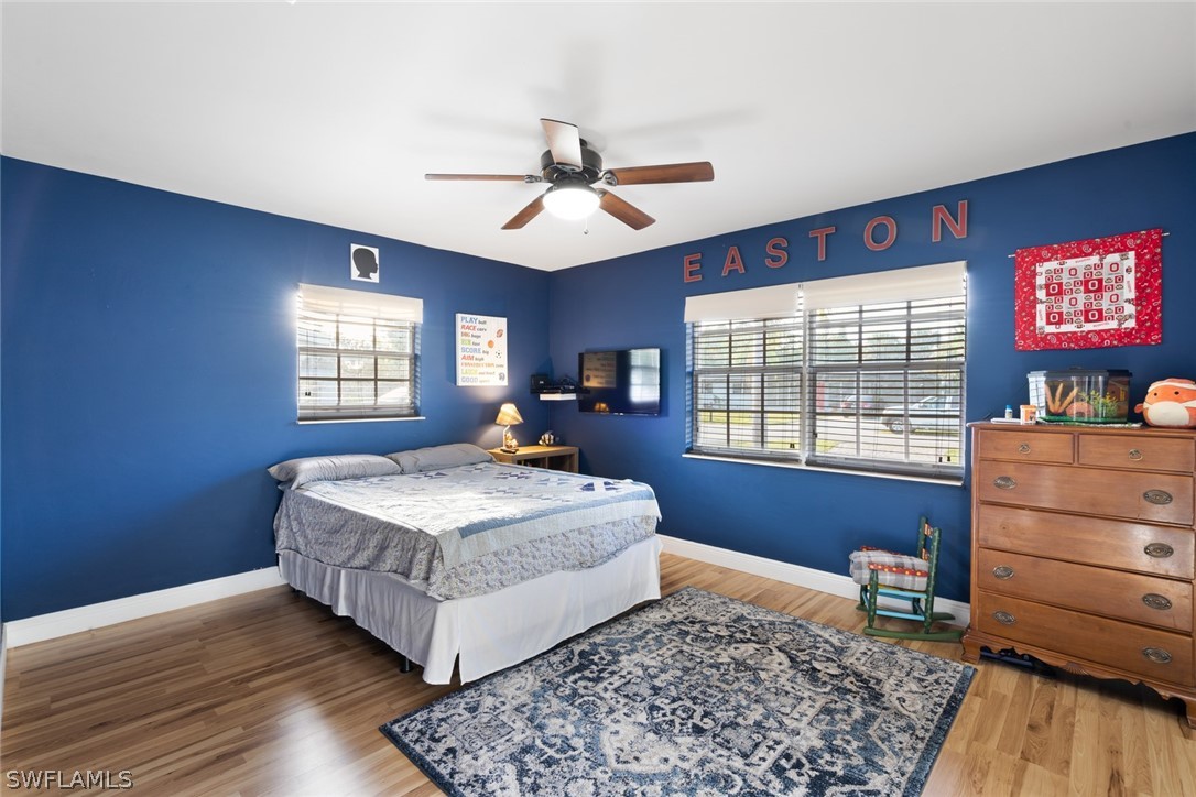 1447 Collins Road Fort Myers, FL 33919 - Photo 21 of 34 a living room with a bed furniture flat screen tv and window