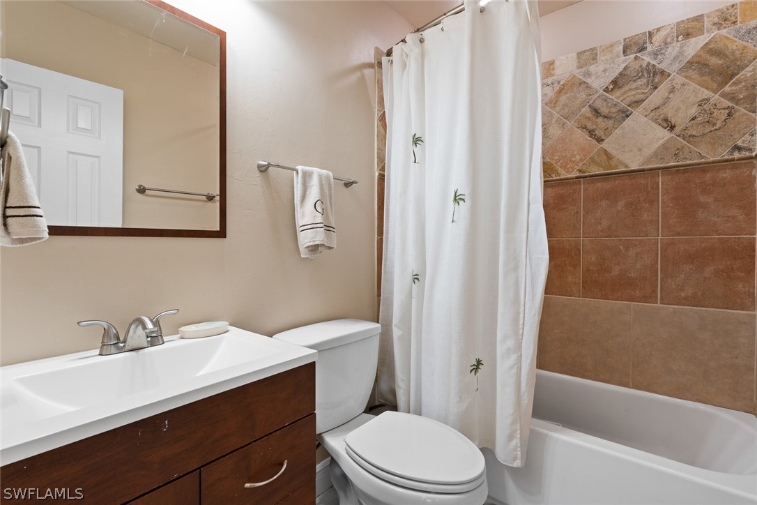 1447 Collins Road Fort Myers, FL 33919 - Photo 23 of 34 a bathroom with a sink a toilet and shower