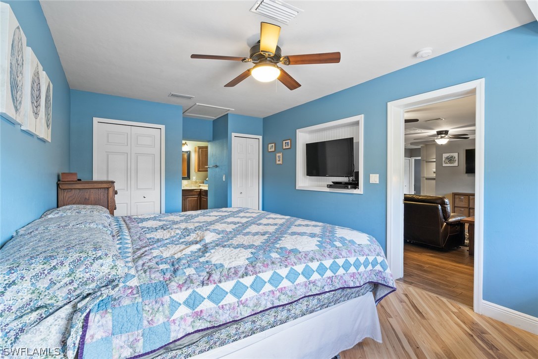1447 Collins Road Fort Myers, FL 33919 - Photo 25 of 34 a bedroom with a bed and a flat tv screen on dresser